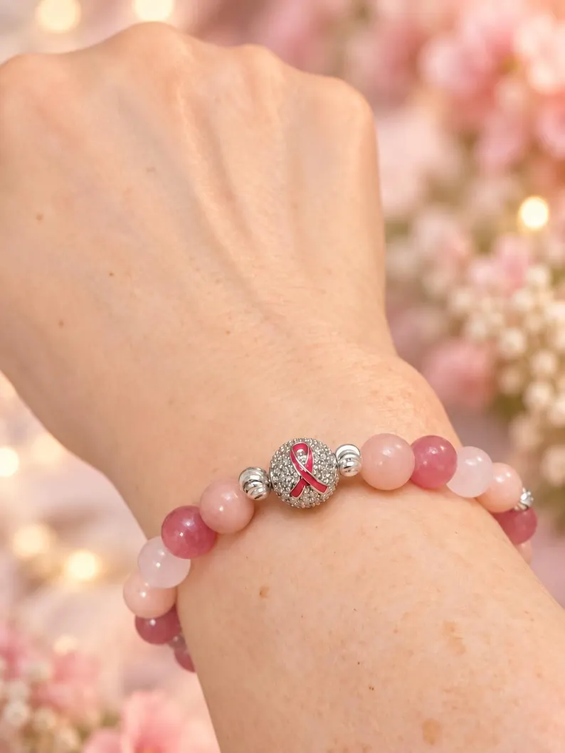 Pink gemstone Breast Cancer Awareness bracelet worn on wrist