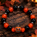 Style 2 orange and black Halloween pumpkin bracelet on dark seasonal background