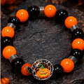 Style 4 orange and black jack-o'-lantern Halloween bracelet on dark seasonal background