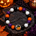 Style 5 purple orange black and white Halloween bracelet with ornate pumpkin and skull charm on dark slate