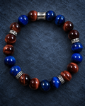 Men's Lapis Lazuli Colored Tiger Eye and Red Tiger Eye bracelet with silver-tone findings on a blue textured background