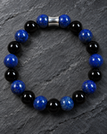 Men's Lapis Lazuli and Black Obsidian 10mm bracelet with silver-tone accent on dark slate