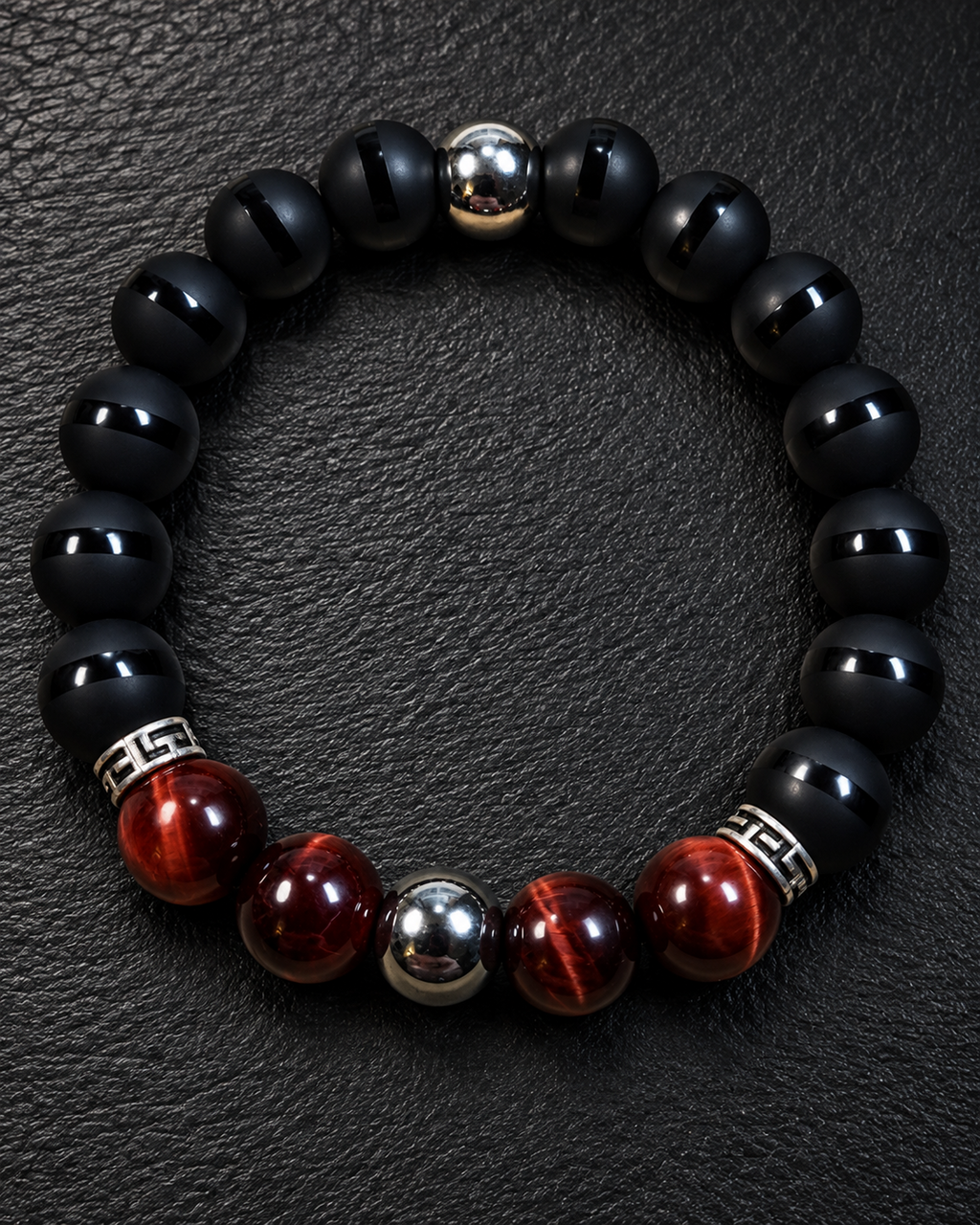 Men's Red Tiger Eye, striped matte Onyx, and Hematite 10mm bracelet on charcoal slate