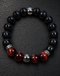 Men's Red Tiger Eye, striped matte Onyx, and Hematite 10mm bracelet on charcoal slate