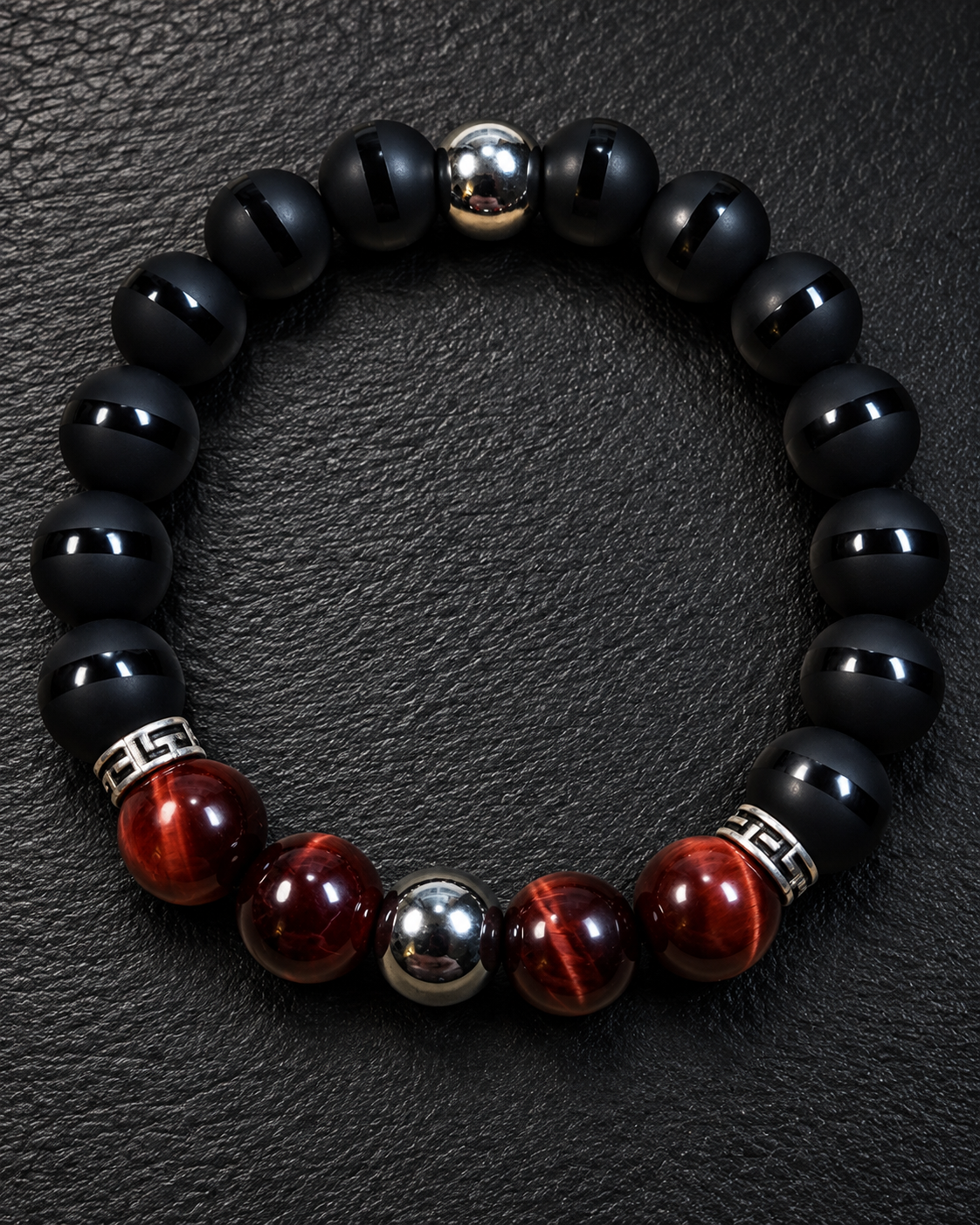 Men's Red Tiger Eye, striped matte Onyx, and Hematite 10mm bracelet on charcoal slate